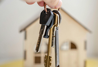 Equity Release keys next to a house.